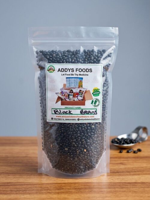 Addys Black Beans pouch on a wooden surface beside a scoop of beans